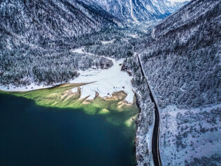 Winter magic in the Julian Alps. Lake Predil seen from above. Between snow and ice.