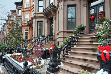 Christmas in New York City with long row of traditional brownstone townhouses