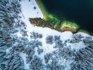 Winter magic in the Julian Alps. Lake Predil seen from above. Between snow and ice.
