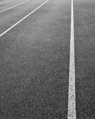 Fototapeta premium Empty running track with lane markings during early morning light in a quiet location