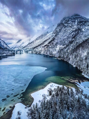 Winter magic in the Julian Alps. Lake Predil seen from above. Between snow and ice.