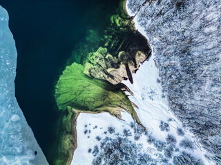 Winter magic in the Julian Alps. Lake Predil seen from above. Between snow and ice.