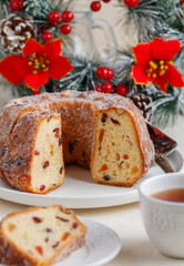 Freshly baked Kuglof, kougelhopf, Alsatian brioche with raisins, candied fruits, orange peel and almonds. Christmas mood. Easter. Selective focus