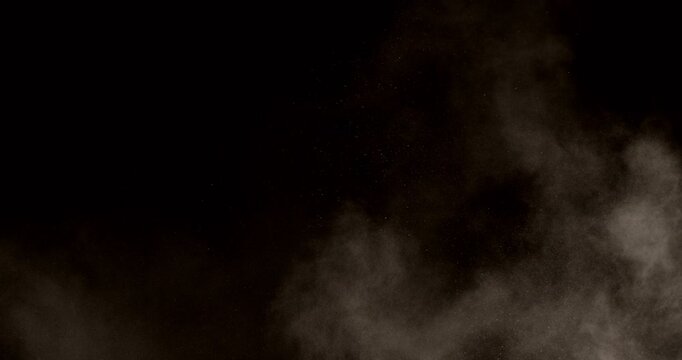 Super slow motion dust particle explosion captured at 500 fps with a high-speed camera. Expanding cloud of fine powder and debris, isolated on black background. Ideal as realistic VFX overlay.