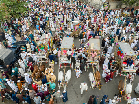 Aerial view of a bustling street filled with vibrantly decorated carts pulled by white bulls amidst a sea of people, Dhaka, Dhaka Division, Bangladesh.