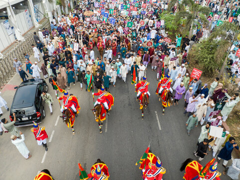 Aerial view of a vibrant procession with horses and crowds fills the streets, a cultural spectacle unfolding, Dhaka, Dhaka Division, Bangladesh.