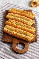 Homemade Rollini with Chicken on a Wooden Board, side view.