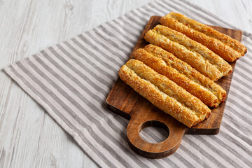 Homemade Rollini with Chicken on a Wooden Board, side view. Copy space.