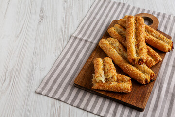 Homemade Rollini with Chicken on a Wooden Board, side view. Copy space.