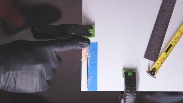 Close-up of a power tool drilling and creating a countersink hole in a wooden board