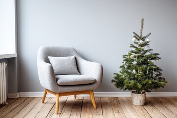 Minimalist interior setting features a modern armchair beside a small decorated evergreen tree