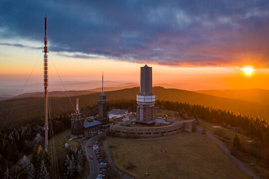 Aerial view of the Grosser Feldberg's towers piercing through the sunset glow, illuminating the autumn landscape, Schmitten im Taunus, Hessen, Germany.