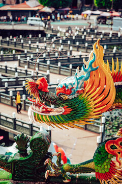 View of vibrant dragon sculpture with intricate details overlooking the maze-like paths of a temple, creating a mesmerizing scene, Taipei City, Taipei City, Taiwan.