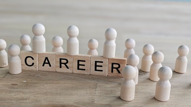 Discussion on career choices with wooden figures and blocks showing the word career