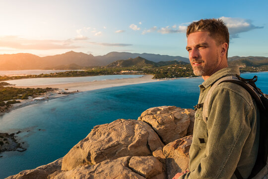Handsome Man Standing on Scenic Viewpoint during Golden Hour, Villasimius, Sardinia, Italy