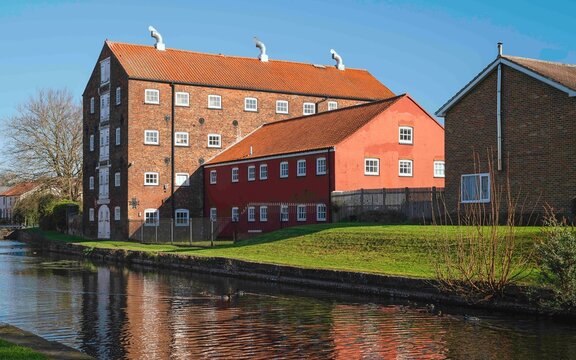 Rear view of ancient, now converted warehouses, and canal head. Driffield, UK.