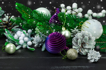 Happy New Year background. Festive Christmas baubles, evergreen branches, pine cones, snowy berries