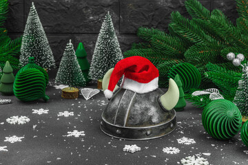 Creepy New Year concept. Handmade Viking helmet with traditional Santa Clause red hat