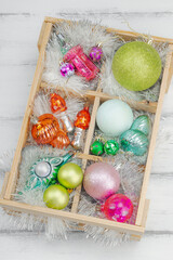 Trendy Kitschmas background. Vintage New Year balls, pink fir tree branches, silver garland