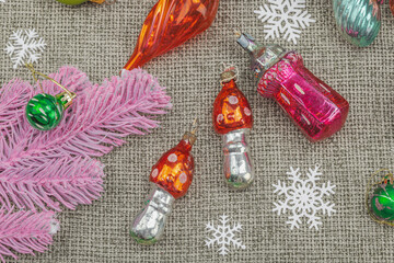 Trendy Kitschmas background. Vintage New Year balls, pink fir tree branches, silver garland