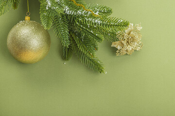 Traditional New Year composition. Festive decor, snowy Christmas tree branches, balls, flowers