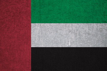 Flag of the UAE on an ancient concrete surface. Concept of Emirati heritage and patriotism.