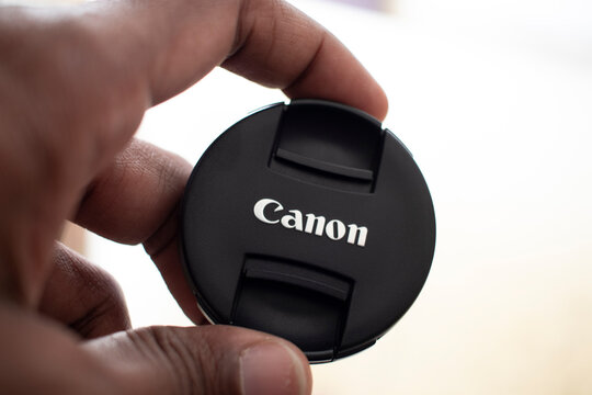 Canon camera lens cap holding in hand - 10 January 2025 Junagadh, Gujarat, India