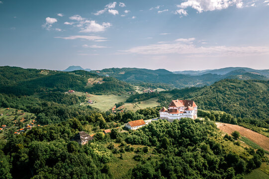Aerial view of the majestic Veliki Tabor Castle perched atop a verdant hill, its terracotta roof contrasting with the lush greenery, Hum Kosnicki, Krapinsko-zagorska zupanija, Croatia.
