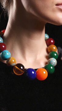 Woman in beaded necklace and black top. Suitable for fashion, jewelry, beauty, and lifestylethemed designs and promotions.