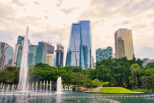 Kuala Lumpur, Malaysia - September 16, 2025: KLCC park on a daytime, street view with lake and modern buildings on a background. This was during the wet season next to the Petronas Towers. 
