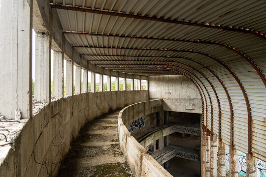 View of concrete curves and corroded metal echo through the skeletal remains of a decaying structure, whispering tales of abandonment, Primorsko, Bulgaria.