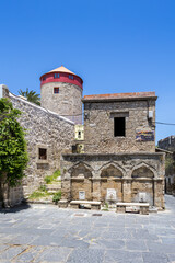 Ottoman fountain and windmill inside historic old town from the Middle Ages on Rhodes island, Greece