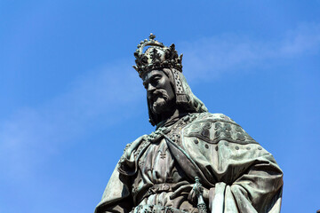 Obraz premium Monumental neo-Gothic statue of Emperor Charles IV from 1844 holding a sword and university charters, Krizovnicke square on the foot of the Charles bridge, Prague, Czech republic