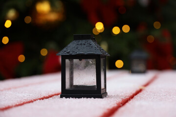 Christmas lantern and festive illumination. New Year decorations on city street, snow winter