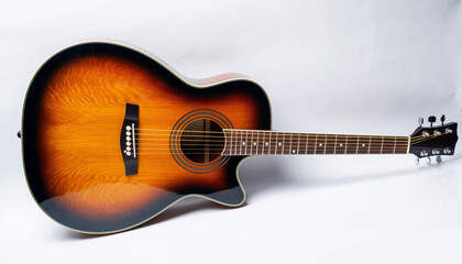 Sunburst acoustic guitar with cutaway on white studio background.