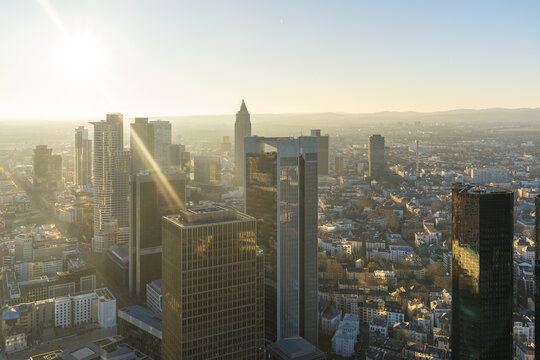 Aerial view of gleaming skyscrapers piercing the horizon as the Main Tower stands tall amidst the urban sprawl, Frankfurt am Main, Hessen, Germany.