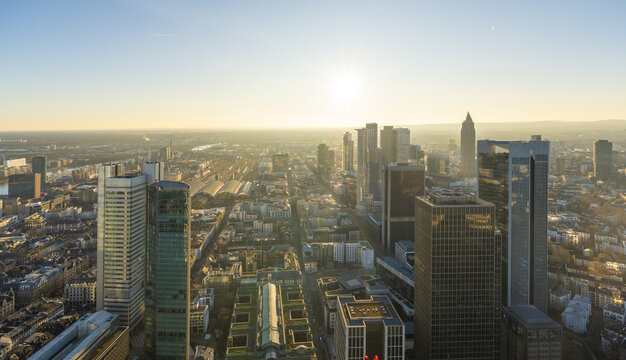 Aerial view of skyscrapers piercing the skyline, bathed in the golden light of the setting sun, a mesmerizing urban panorama., Frankfurt am Main, Hessen, Germany.