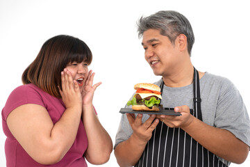 Burger Delight: A smiling individual presents an appealing burger to another, capturing a moment of food anticipation and excitement.