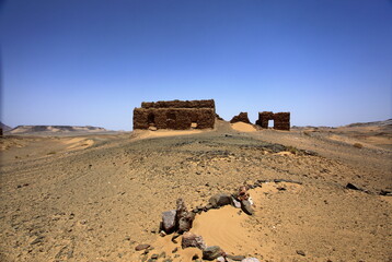 View of ancient ruins atop a sandy hill under a vast, clear sky, whispering tales of time in the arid landscape, Noshki, Balochistan, Pakistan.