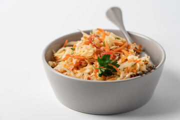 Fresh Coleslaw Salad in Gray Bowl on White Background, Healthy Food Concept