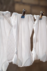 Freshly washed baby clothes hanging