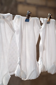 Freshly washed baby clothes hanging
