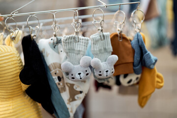 Baby clothes hanging with colorful garments