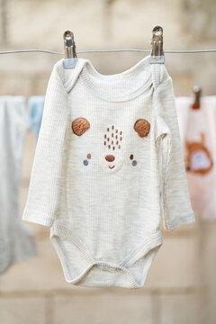 Baby bodysuit with cute design hanging