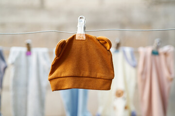 Baby hat hanging on a clothesline