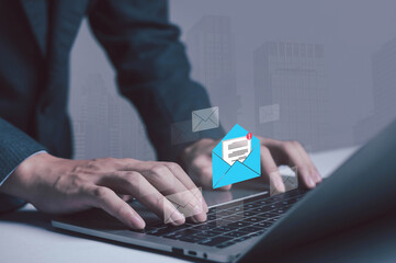 businessman checking email notifications on a smartphone represents digital communication, laptop messaging, and efficient information management in a modern technology-driven workplace.