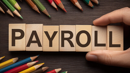 Wooden blocks spelling payroll to represent salary management, employee compensation and structured financial administration.
