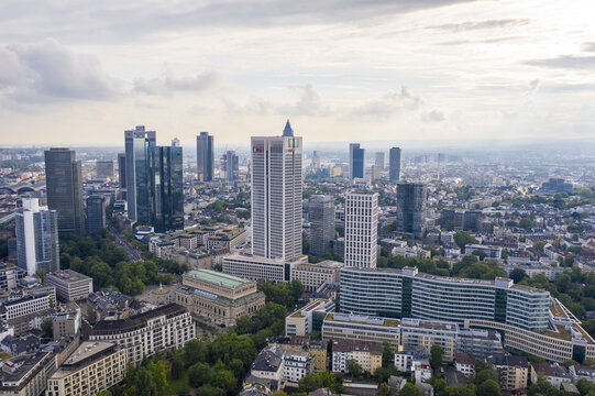 Aerial view of skyscrapers and the Alte Oper contrasting against the leafy cityscape below, Frankfurt am Main, Hessen, Germany.