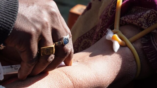 Person injection needle a patient vein for collect blood samples for test purposes 
