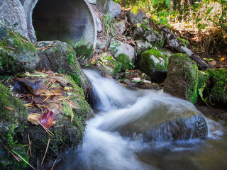 A trickle of water from a pipe long exposure